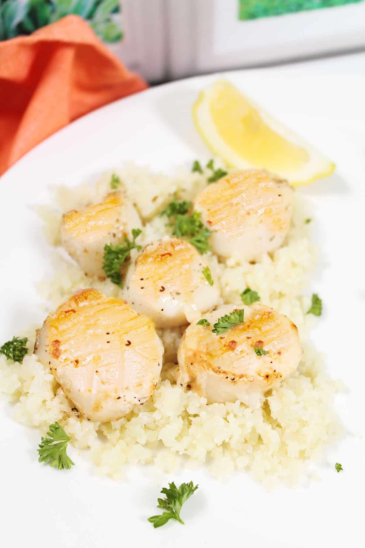 Air Fryer Frozen Scallops cooked over rice.