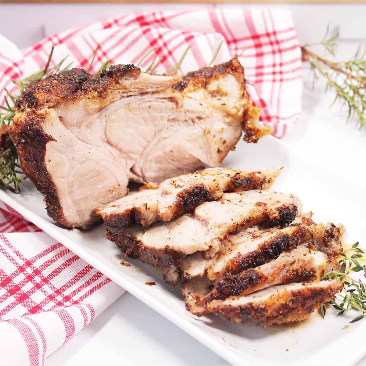 Air Fryer Pork Shoulder Roast sliced on platter.