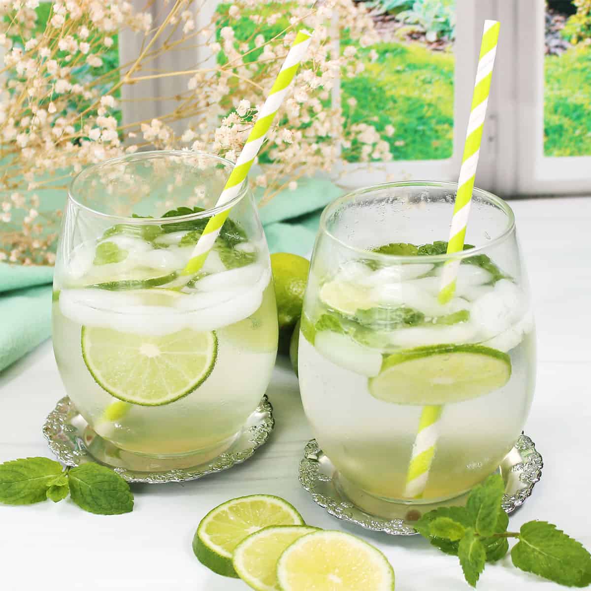 Two Hugo Spritz drinks with mint and lime.