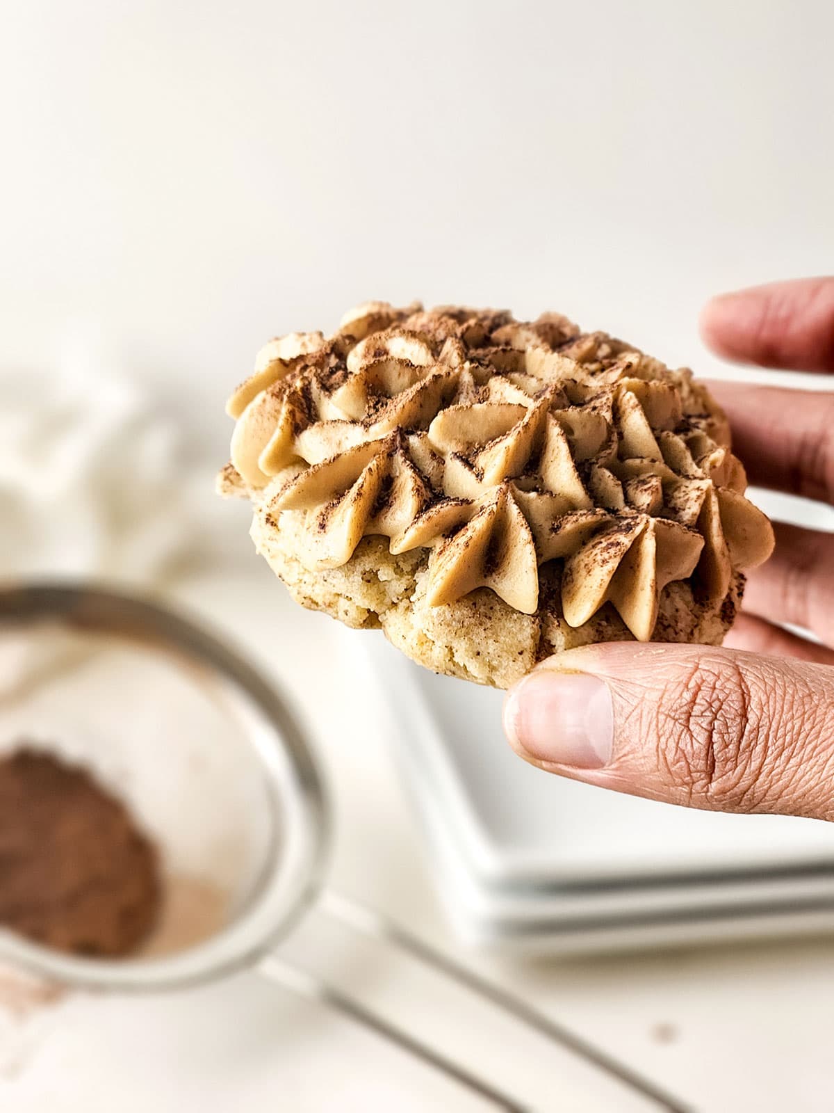 Holding an Italian tiramisu cookie.