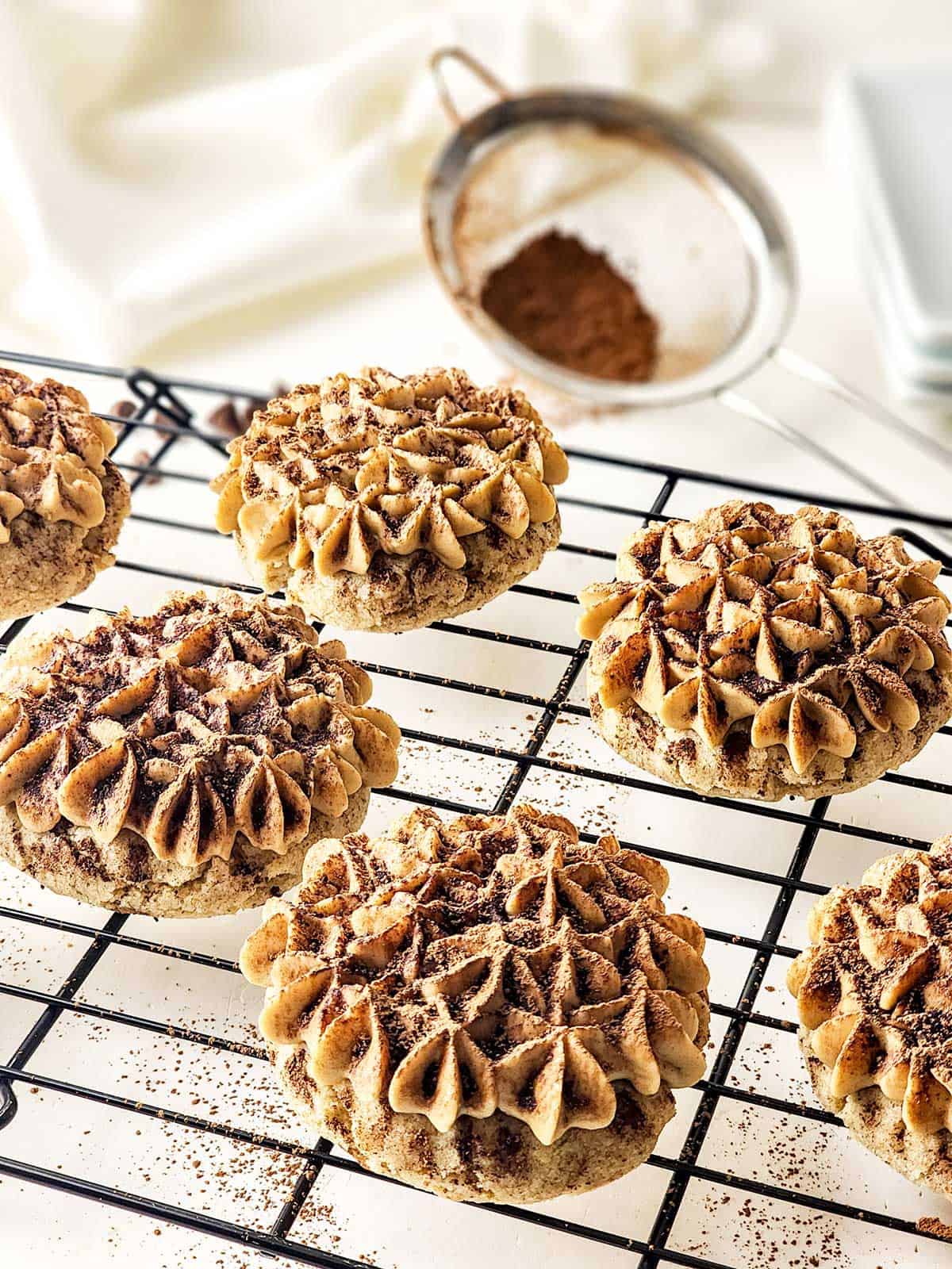 Coffee cookies finished with sprinkle of cocoa powder.