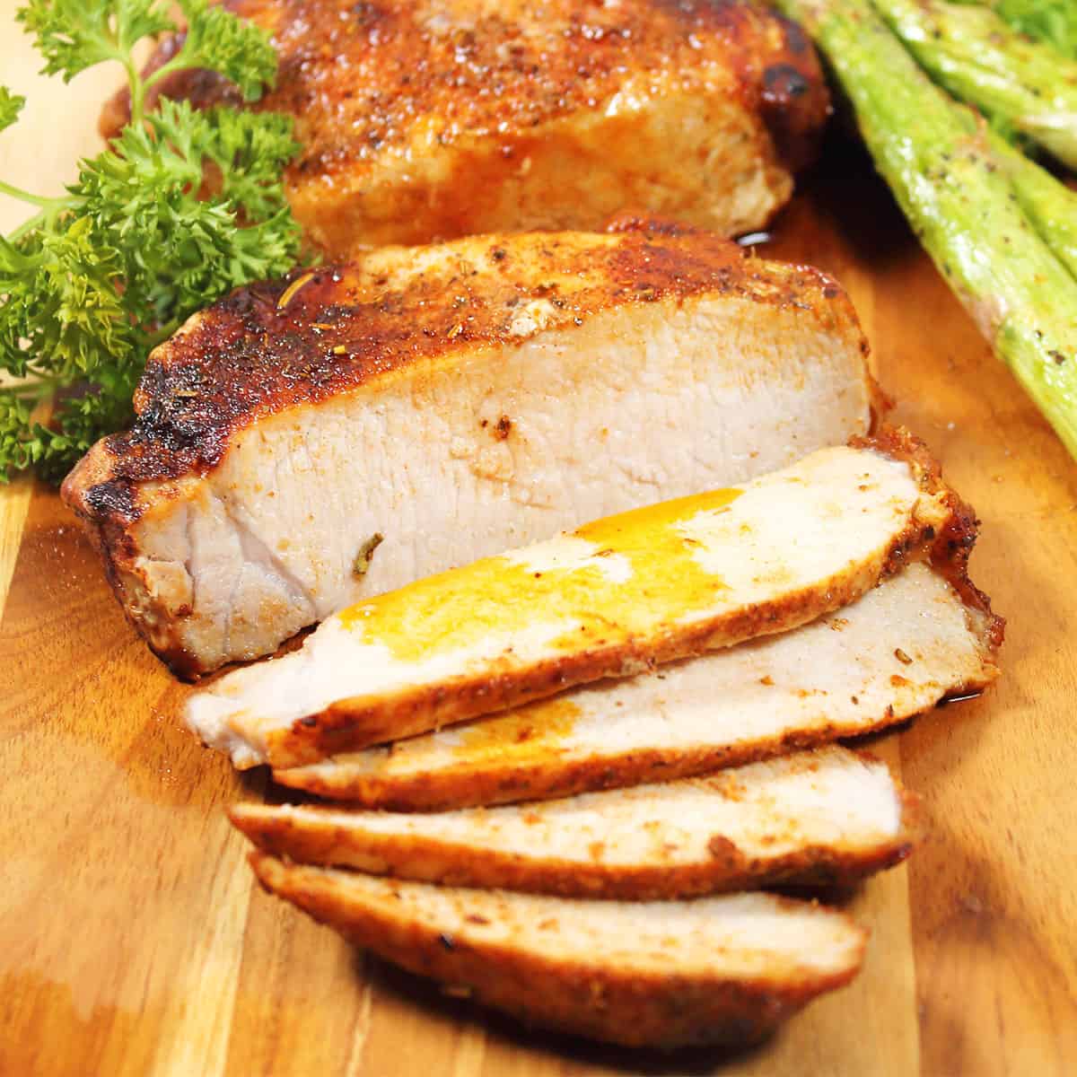 Air fried frozen pork chops in air fryer sliced with gravy.