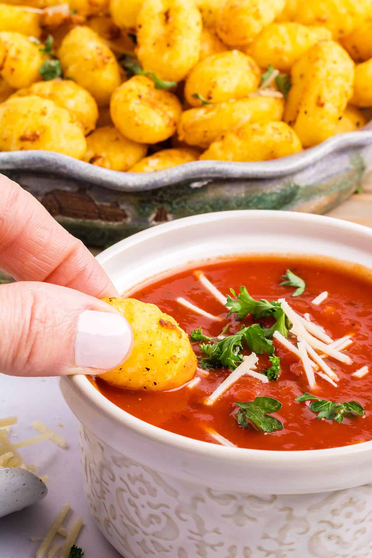 Dipping air fried gnocchi into marinara.