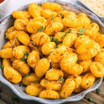 Air Fryer Gnocchi in bowl with parsley garnish.