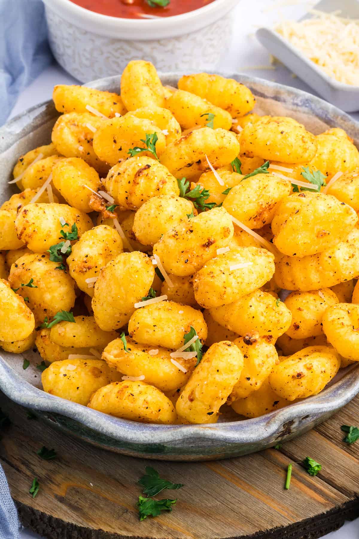 Toasty golden brown gnocchi in serving bowl.