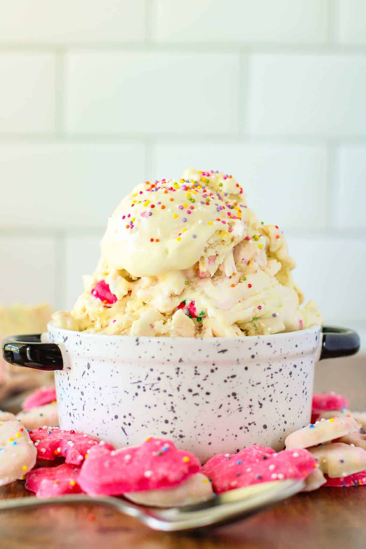 Bowl of frozen ice cream with animal cookies around it.