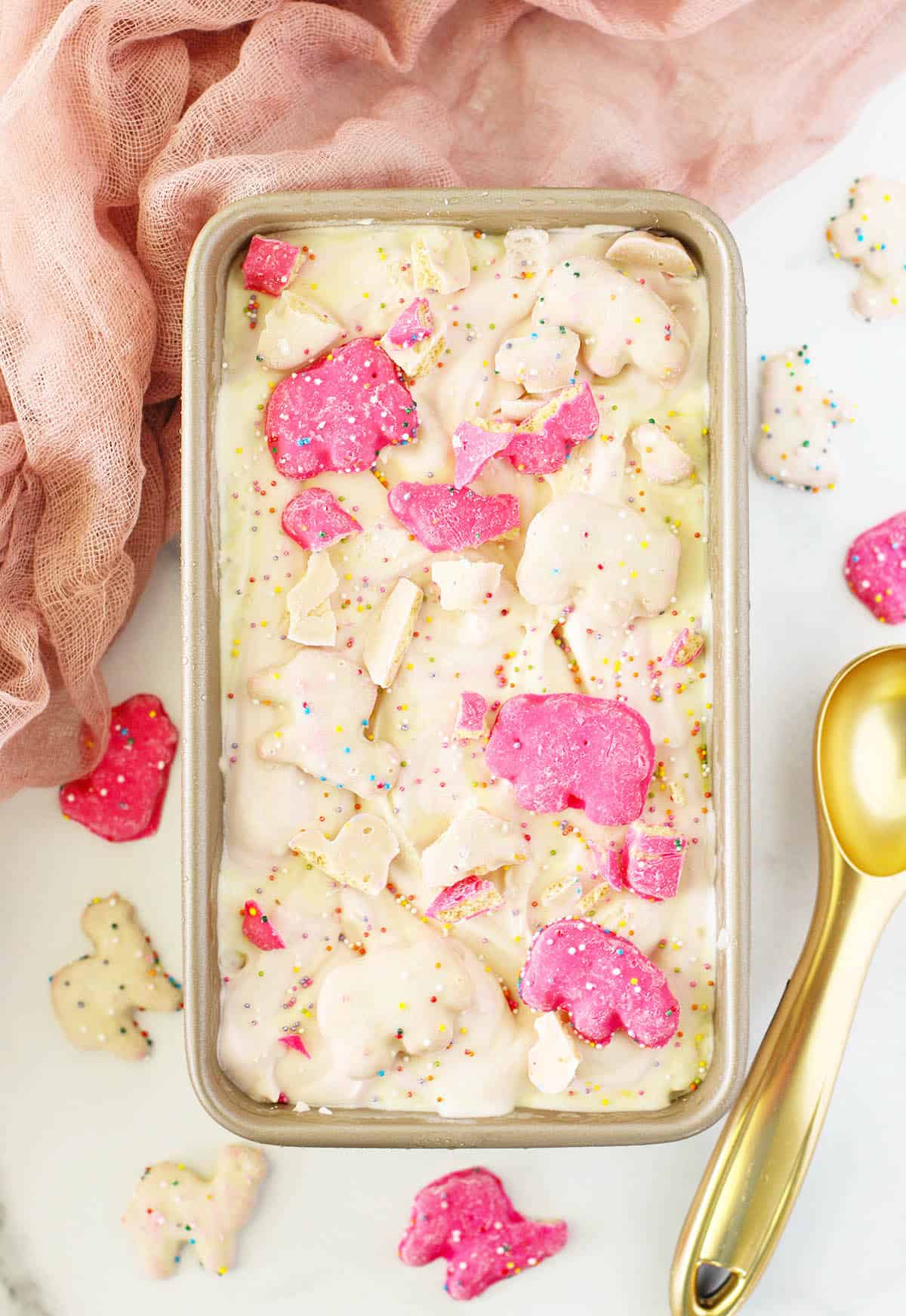 Pan of frozen ice cream with cookie pieces on top.
