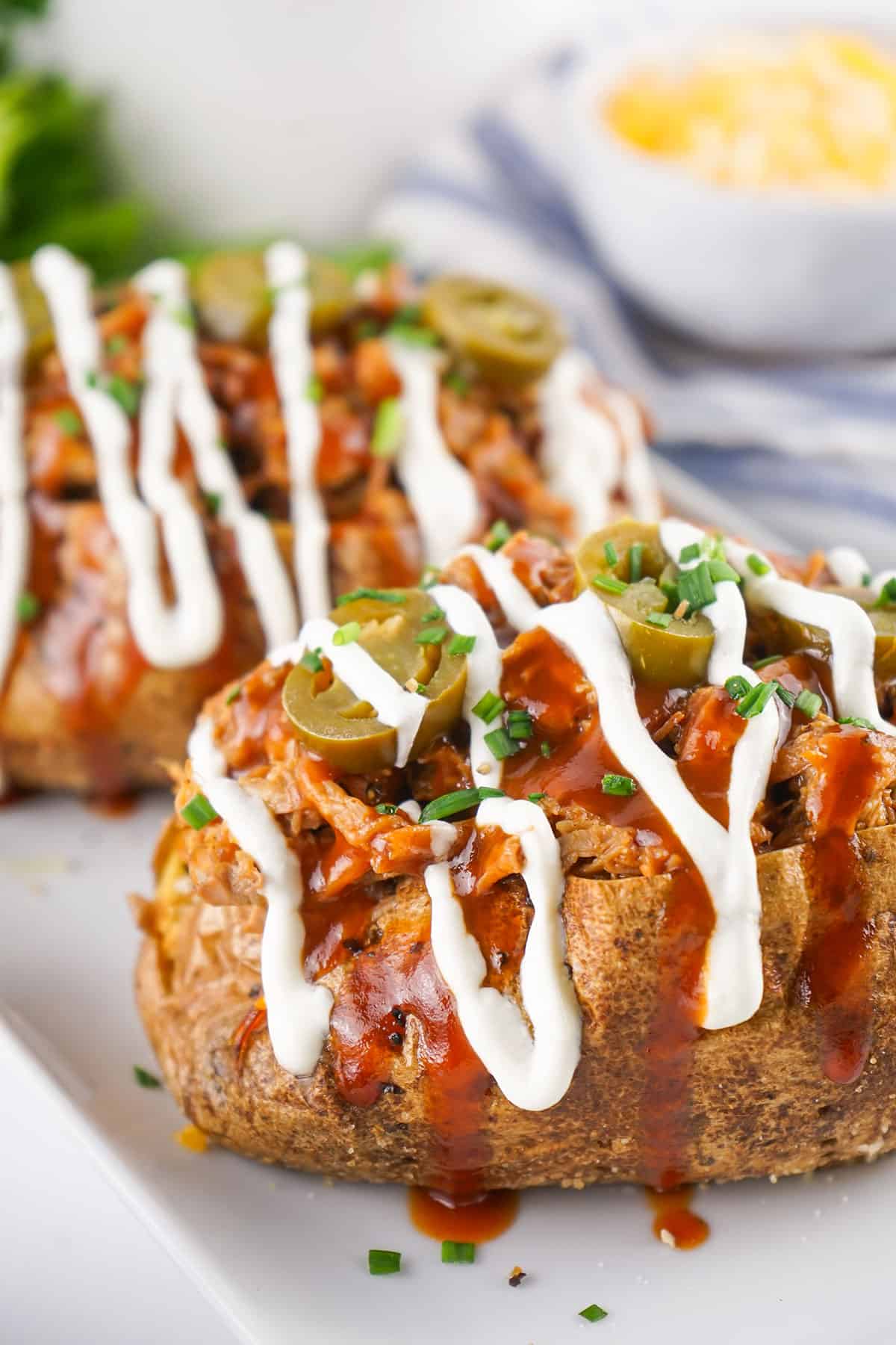 Closeup of dressed pulled pork potatoes.