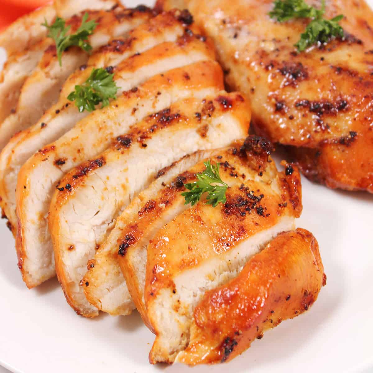 Sliced and plated closeup of cooked air fryer frozen chicken breasts.