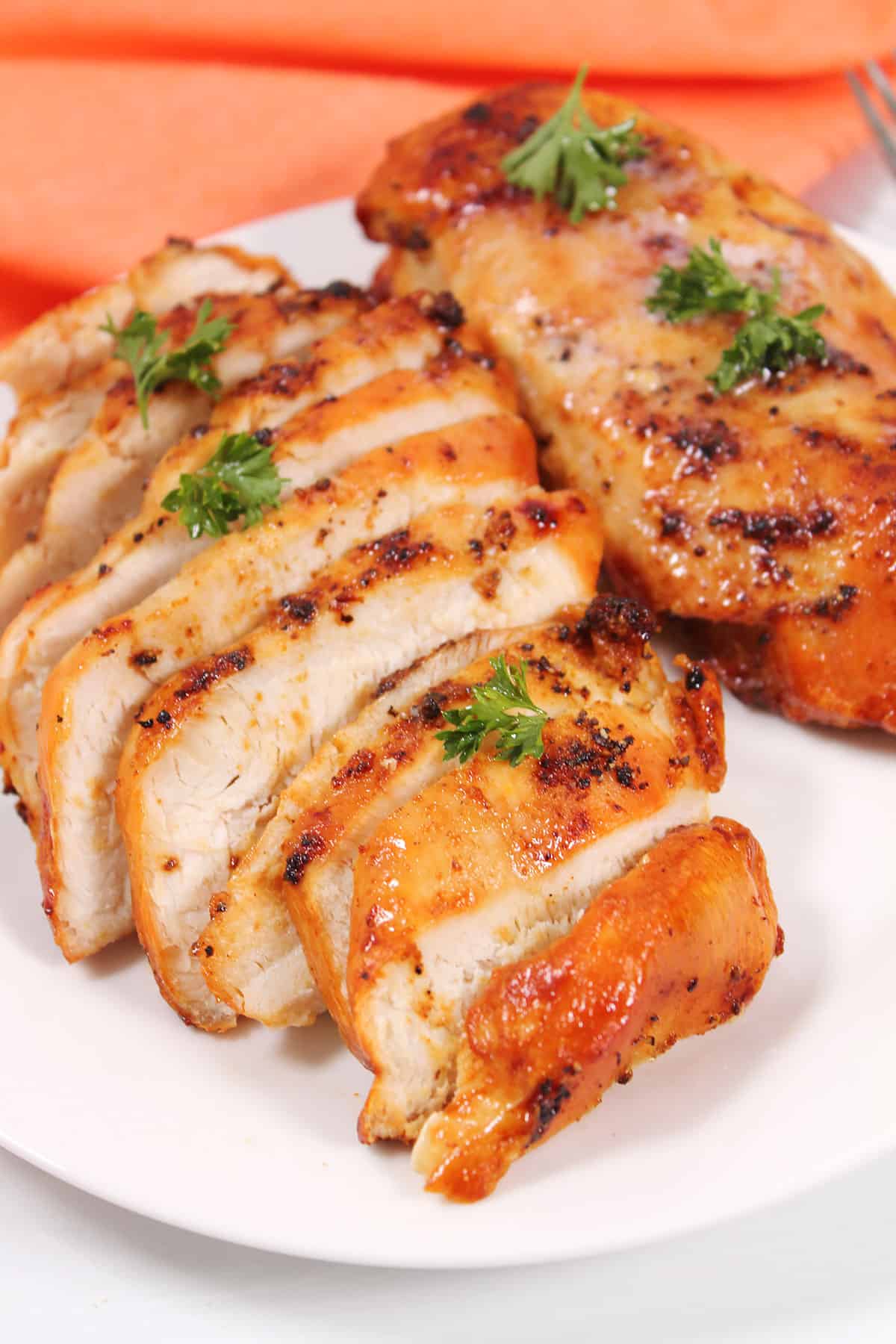 Air Fryer Frozen Chicken Breasts plated and sliced.