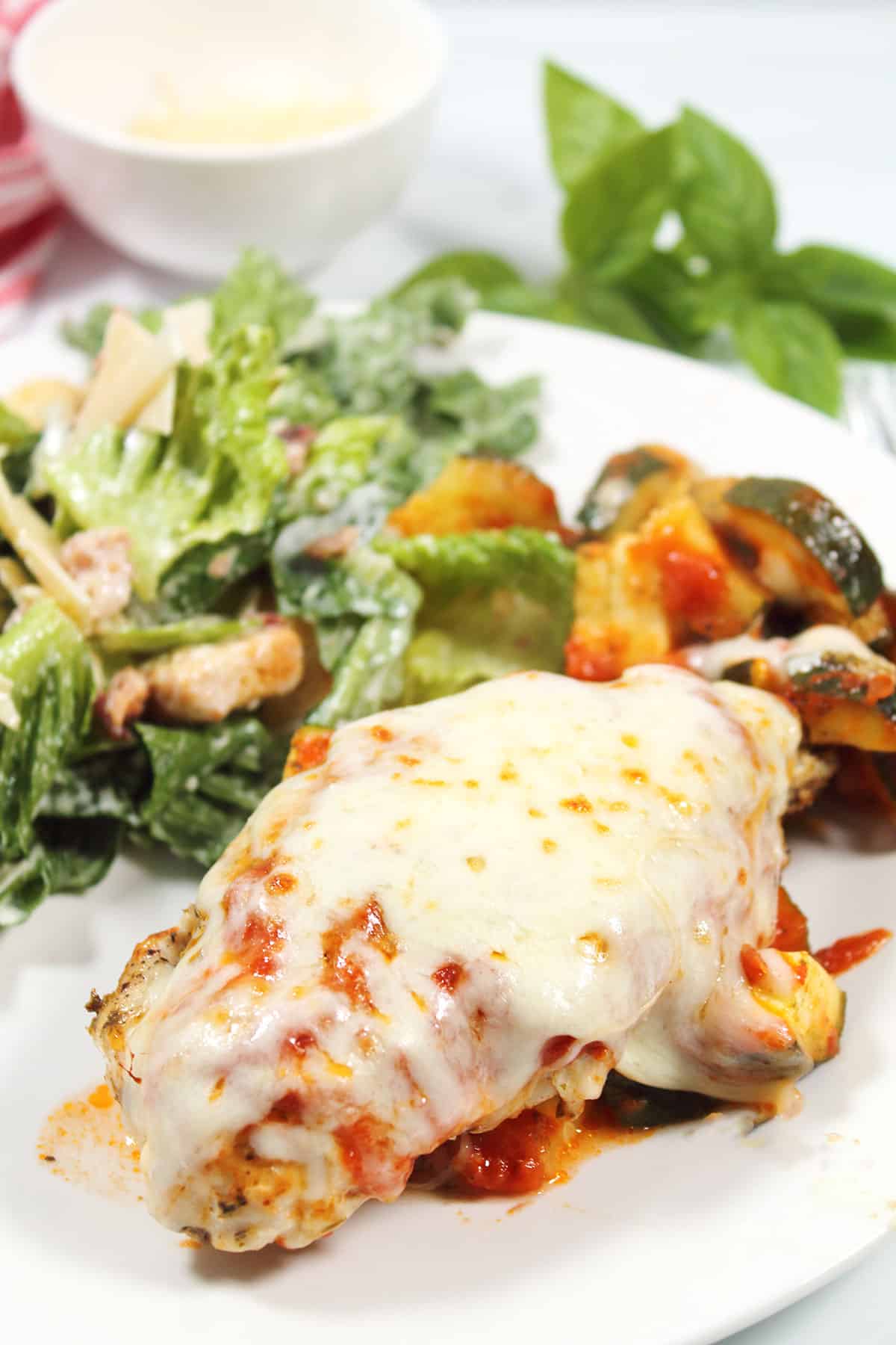 Closeup of air fryer Italian Chicken Foil Packets plated with salad.