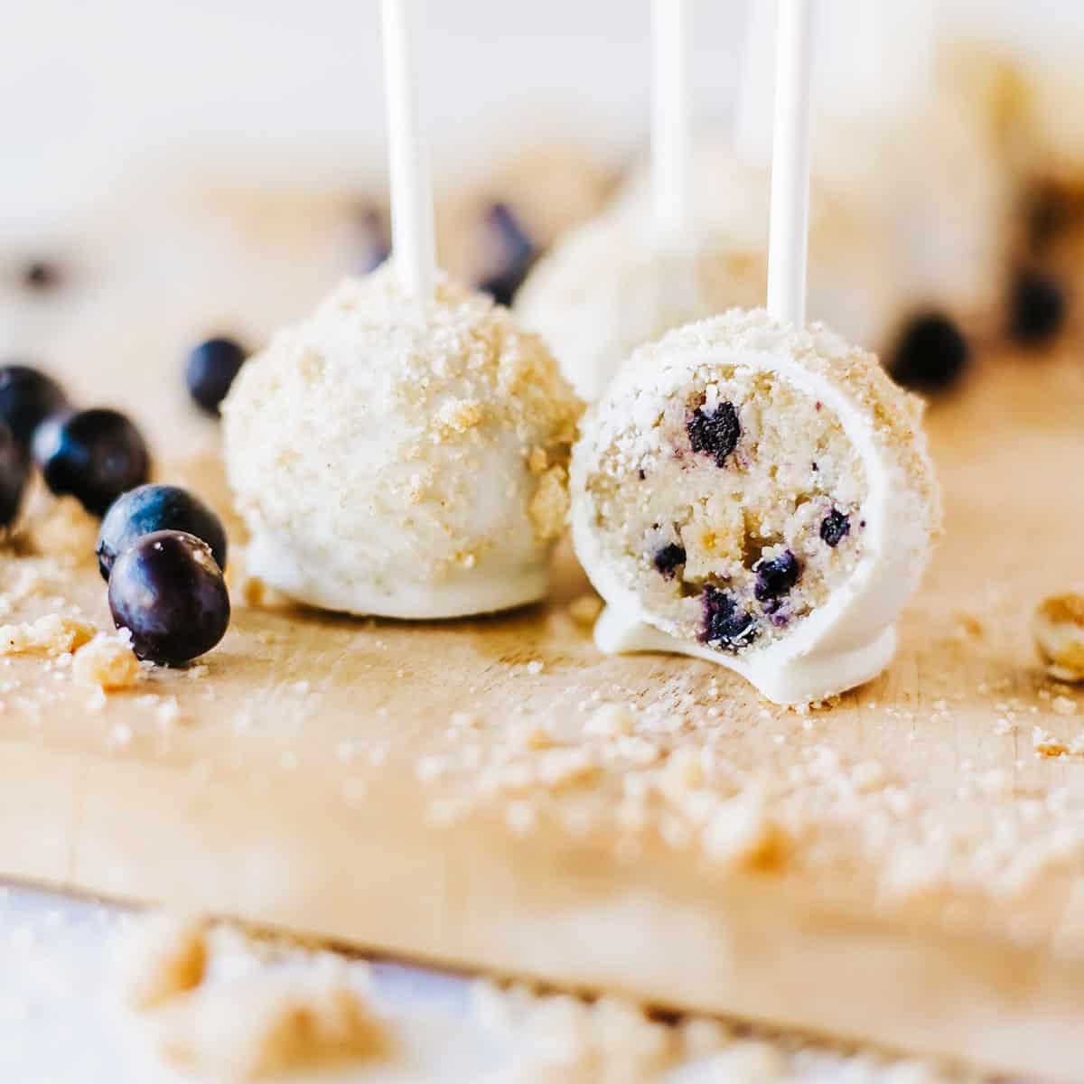 Blueberry muffin cake pops with one halved to show center.