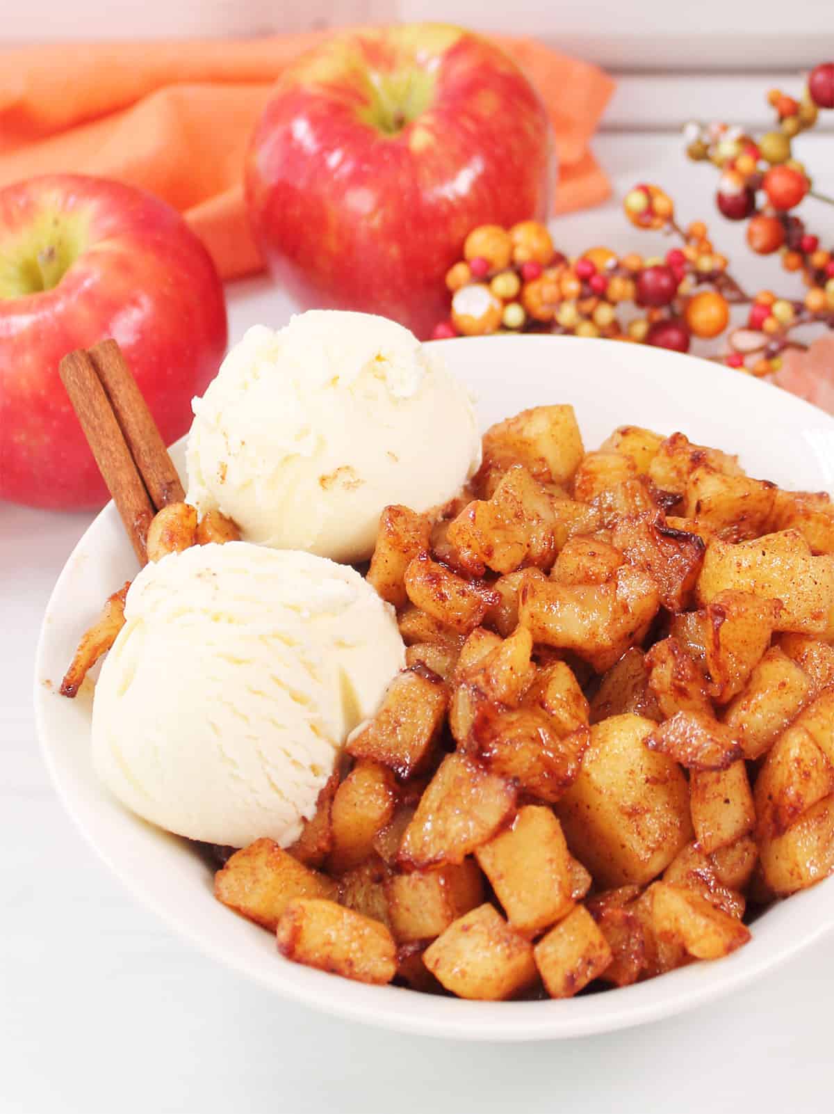 Air Fryer Apples in bowl with scoops of ice cream.