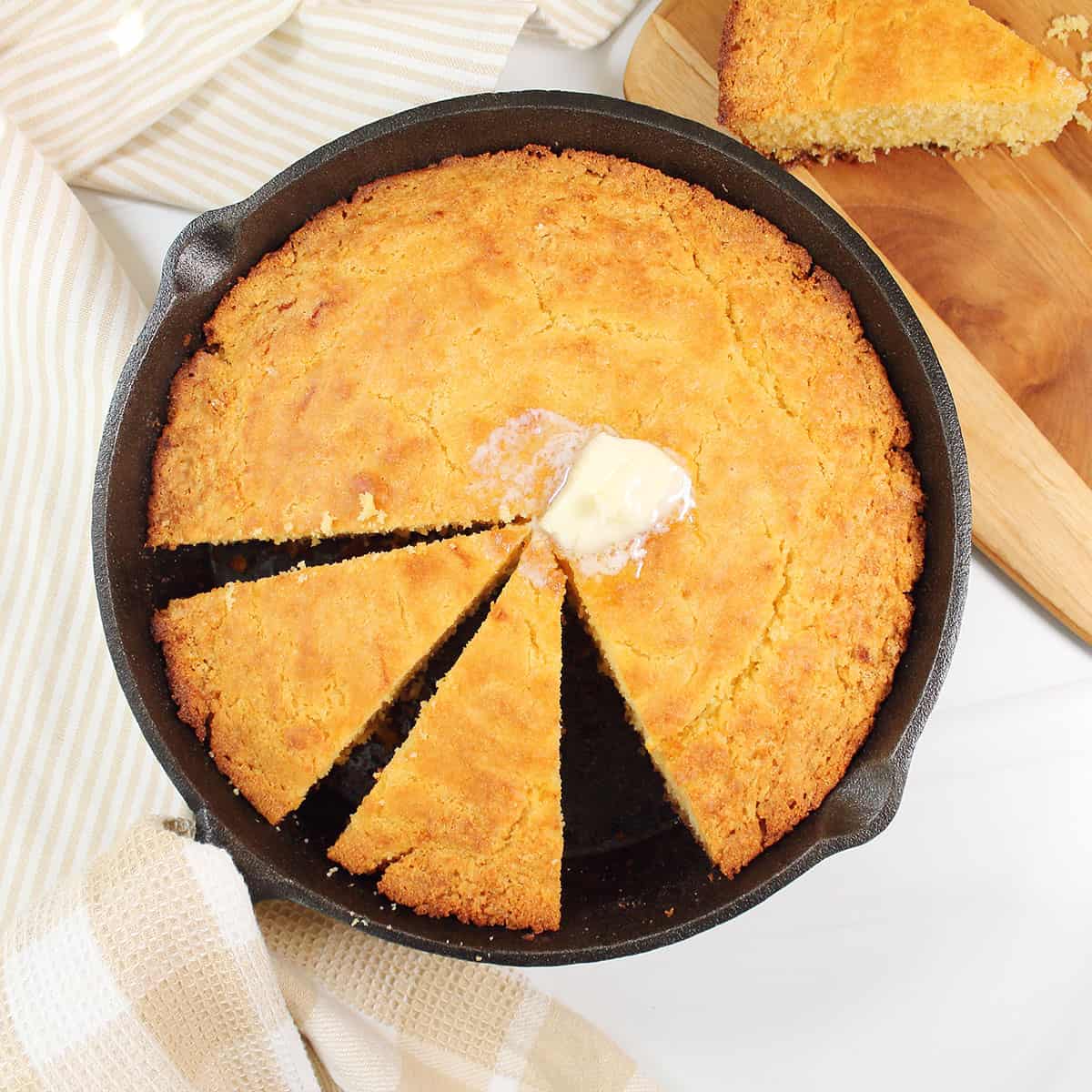 Buttermilk Skillet cornbread sliced in cast iron skillet.