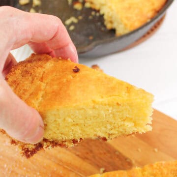 Holding slice of the best buttermilk cornbread.