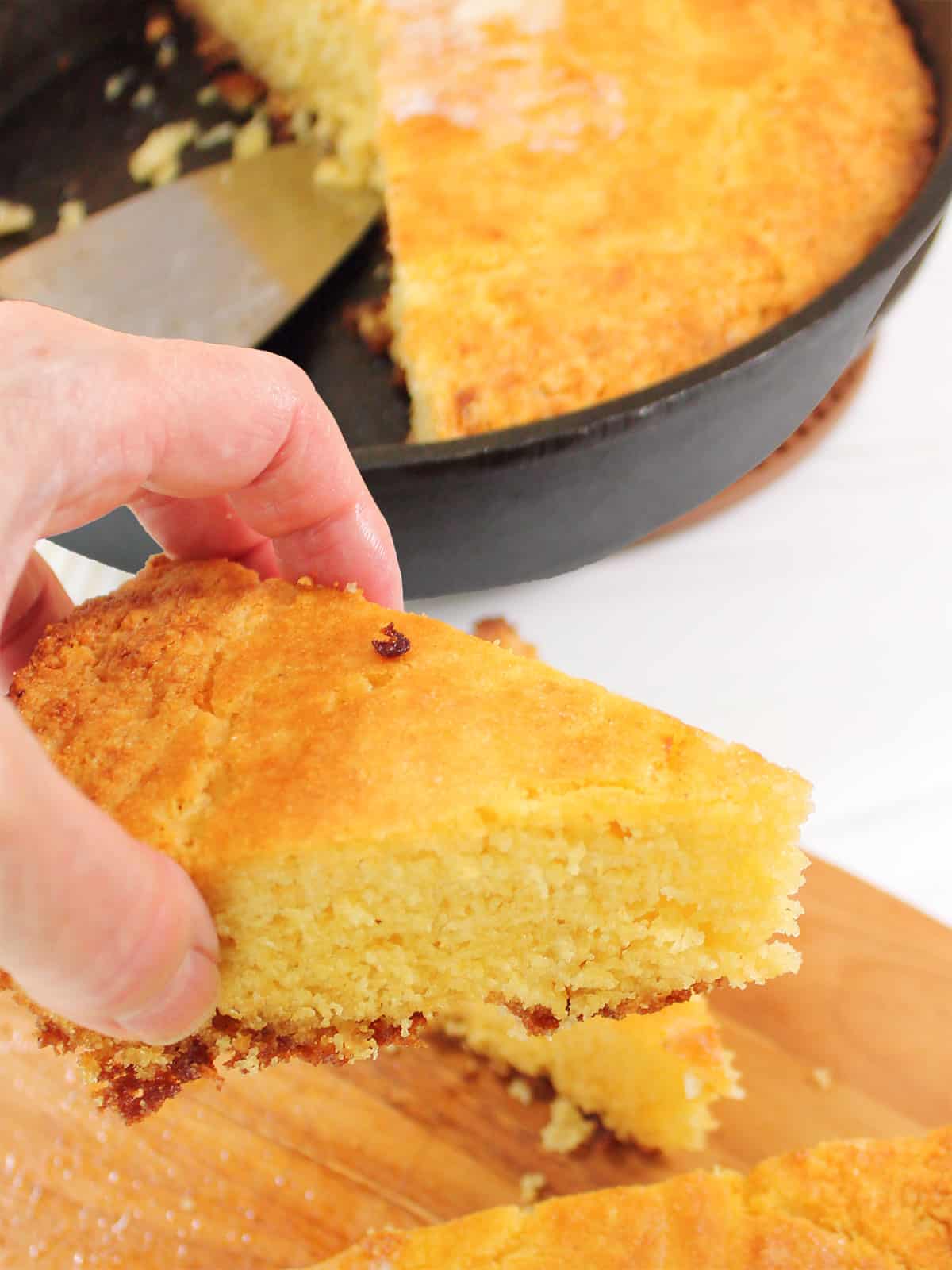 Grabbing a slice of moist, rich cornbread.