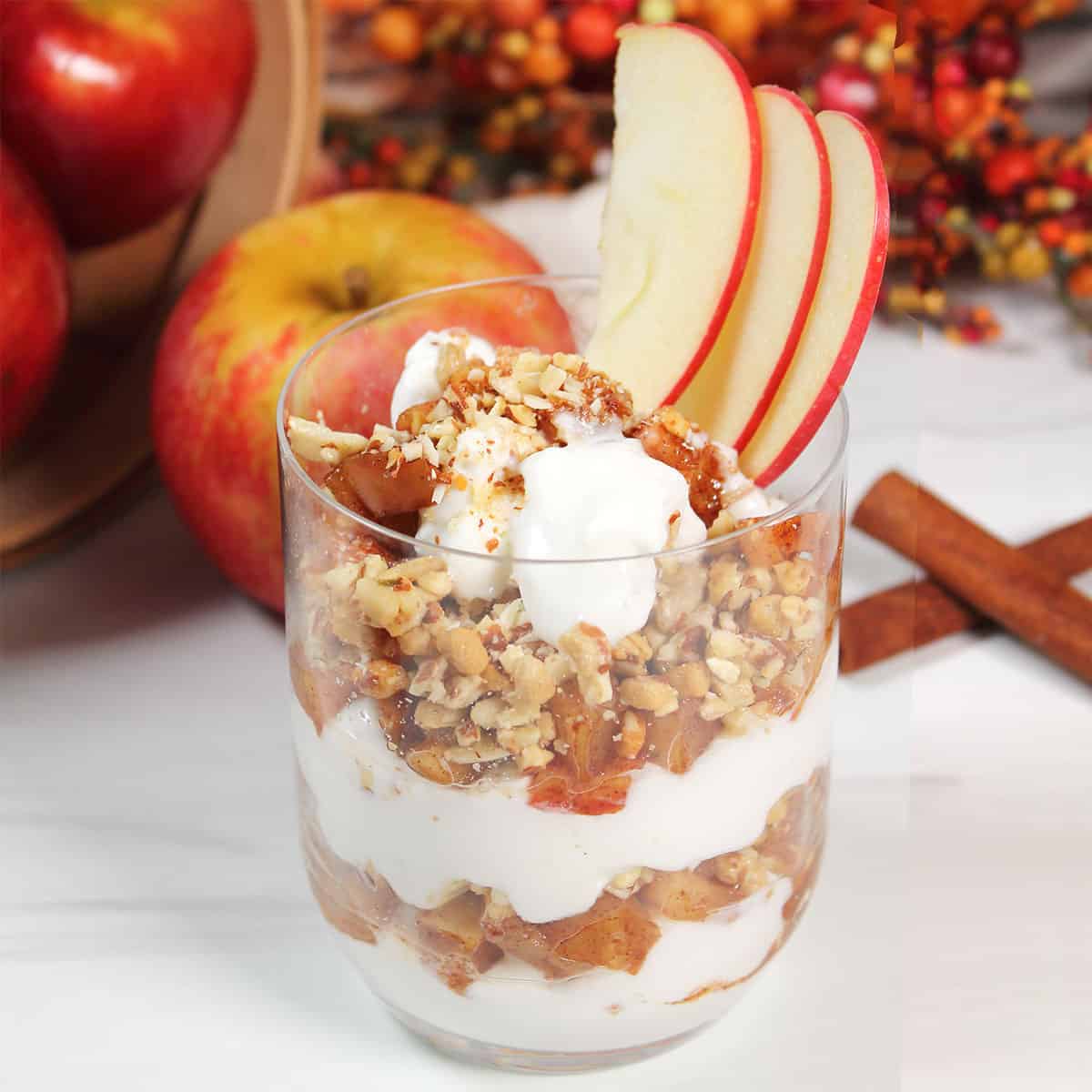 Apple Parfait layered in glass with apple garnish.