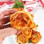 Holding chicken pinwheel over platter.