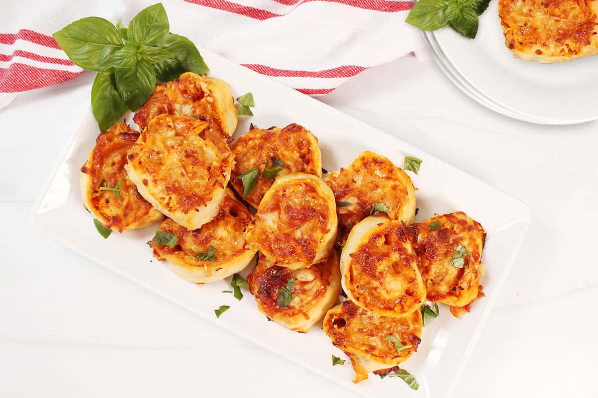 Platterful of chicken parmesan pinwheels.