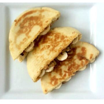 Chocolate Peanut Butter Banana Pita Panini, cut on plate.