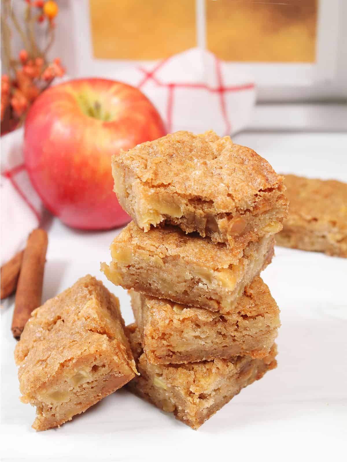 Stack of cinnamon apple blondies with bite out of top one.