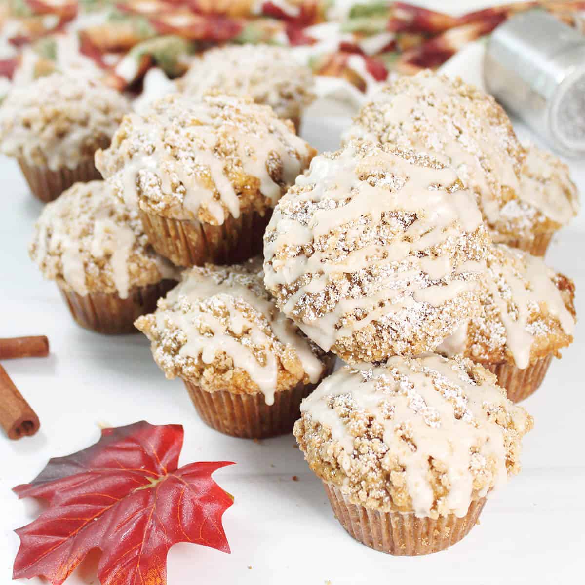 Maple Brown Sugar Oatmeal Muffins on table with fall leaves.