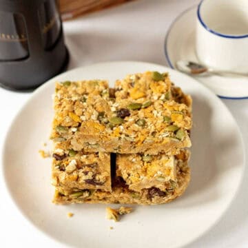 No Bake Cereal Breakfast Bars on plate with coffee cup.