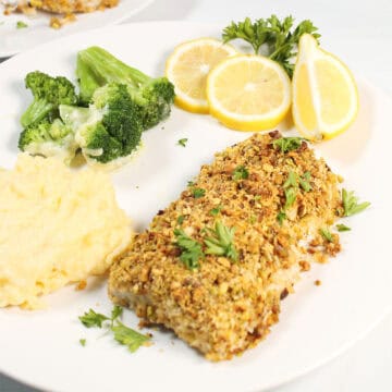 Plated mahi with lemon slices, broccoli and gouda polenta.