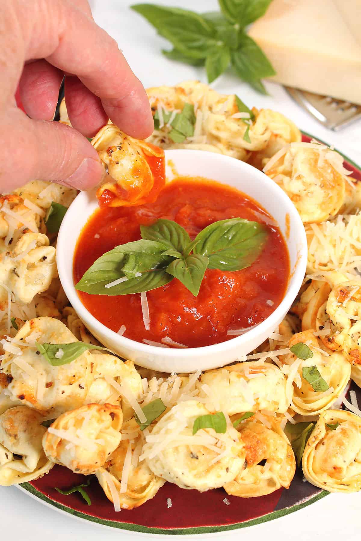 Dipping air fried tortellini into marinara.