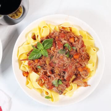 Overhead of bowl of Instant Pot Pork Ragu over pappardelle.