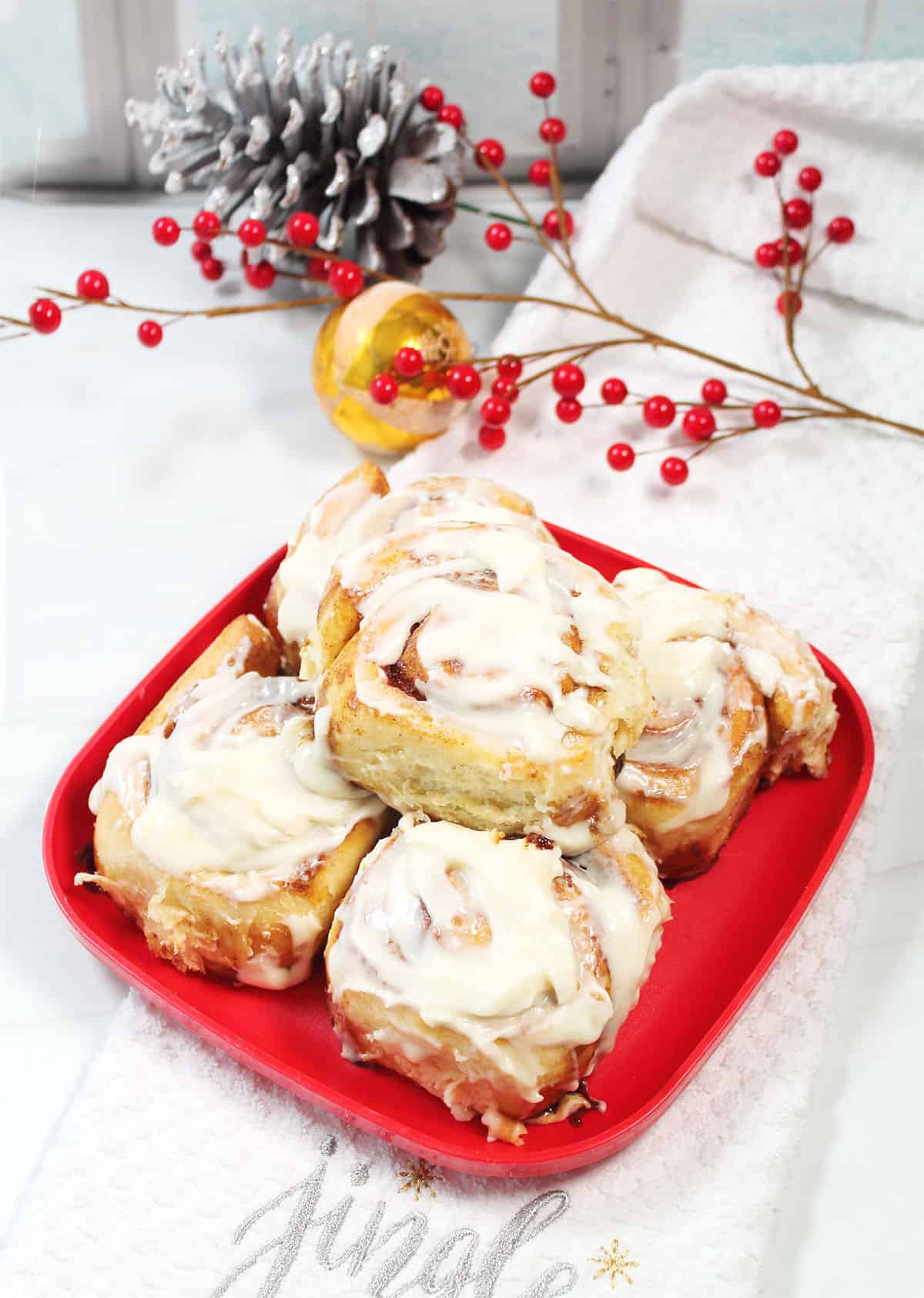 Christmas Cinnamon Rolls on red Christmas plate.