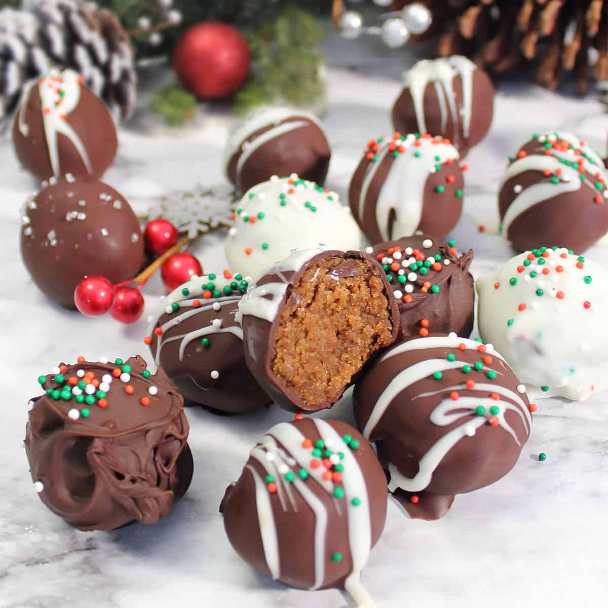 Closeup of pile of gingerbread truffles with bite taken out of one.