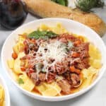 Garnished bowl of pork ragu.