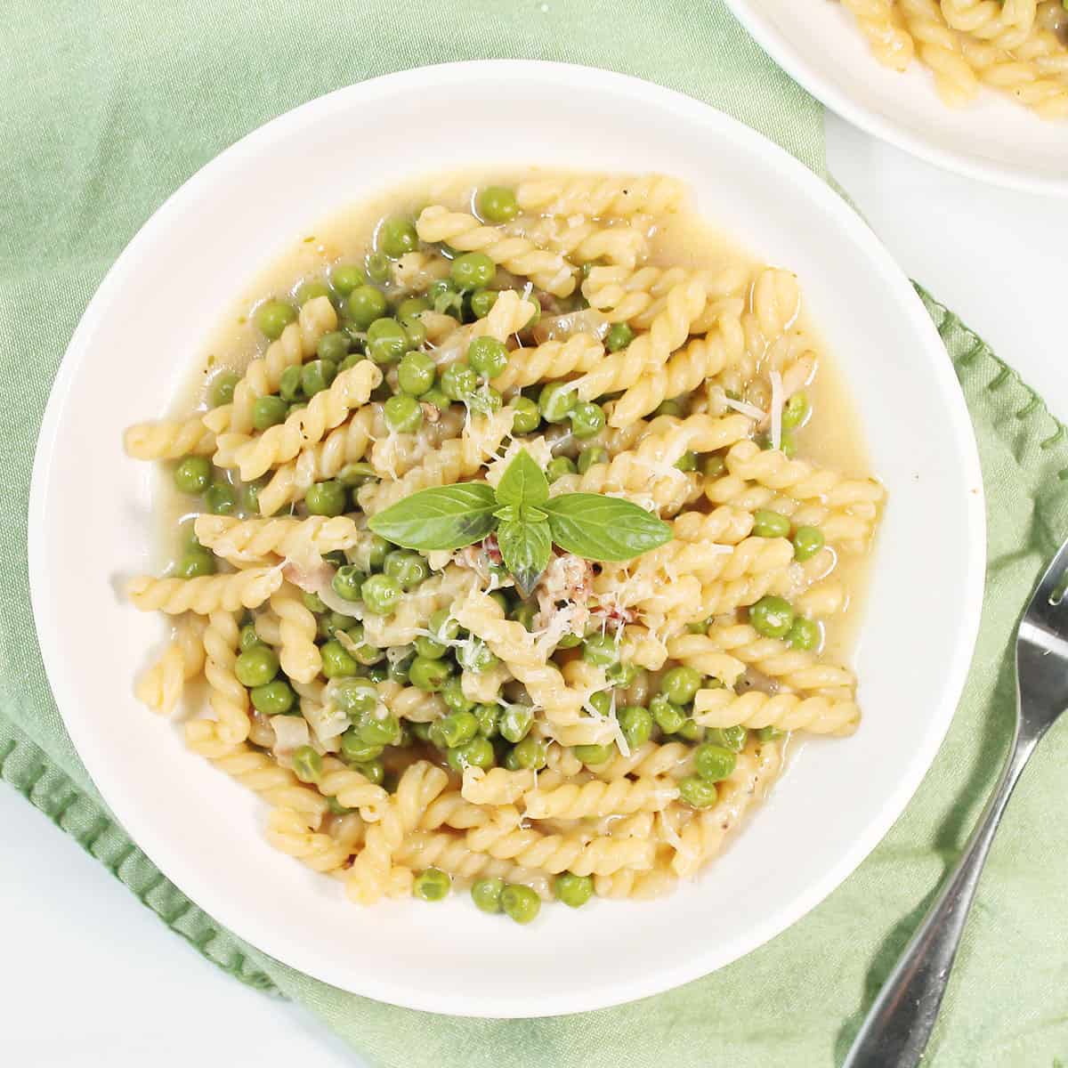 Overhead of pasta with peas in bowl.
