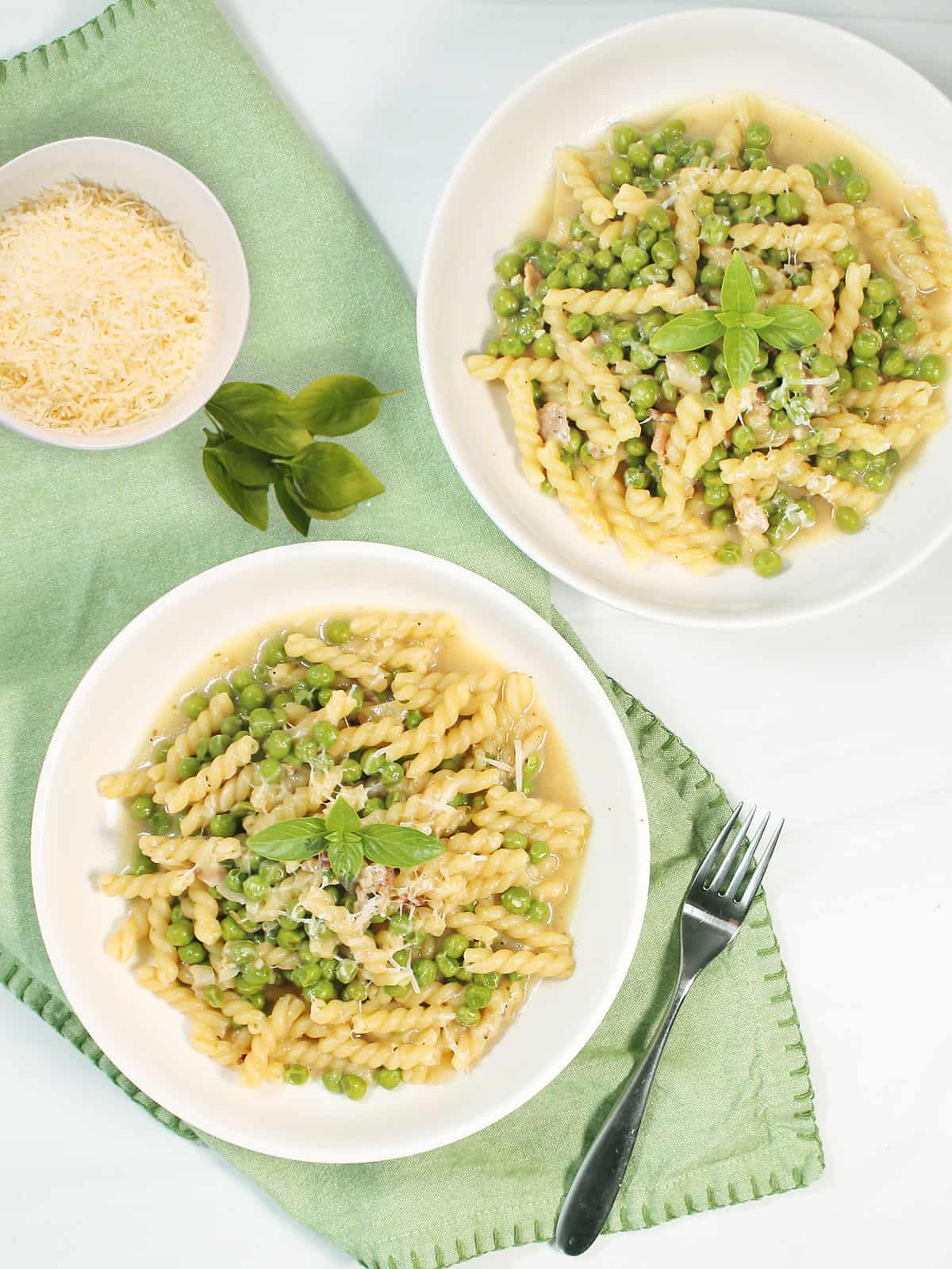 Two servings of pasta with peas overhead.
