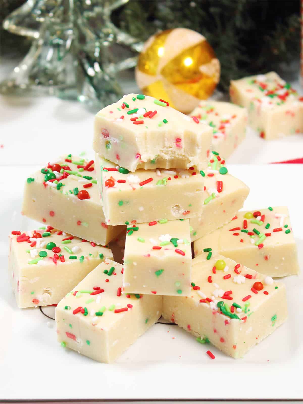 Christmas Sugar Cookie Fudge plated with bite out of top piece.