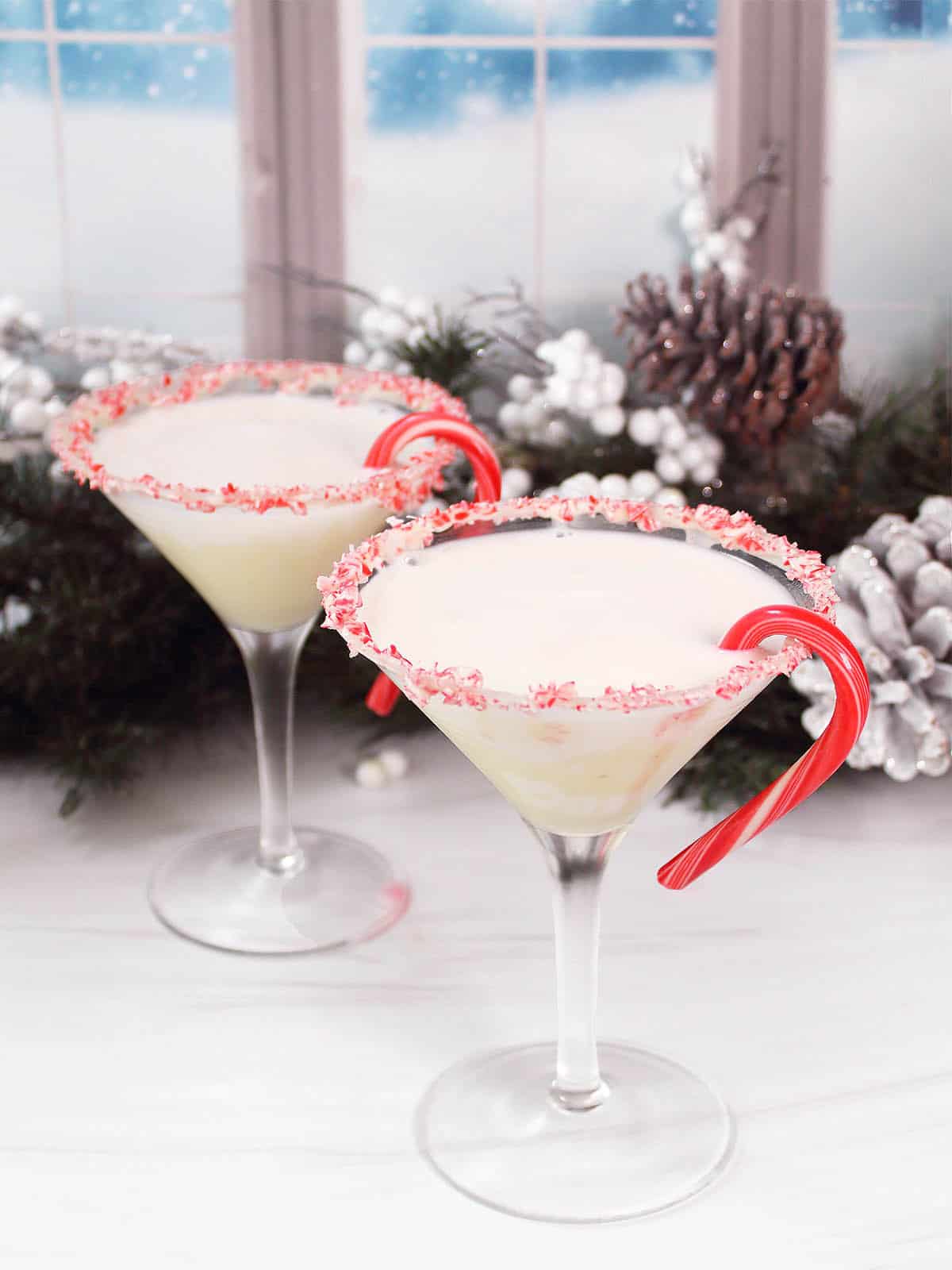 Two Candy Cane Martinis with candy cane rim and candy cane garnish.