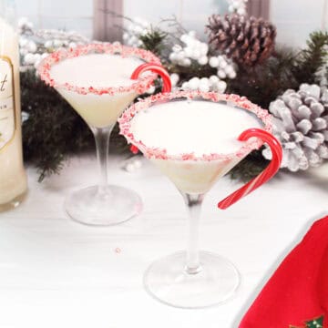 Two Candy Cane Martinis garnished with candy cane rim.