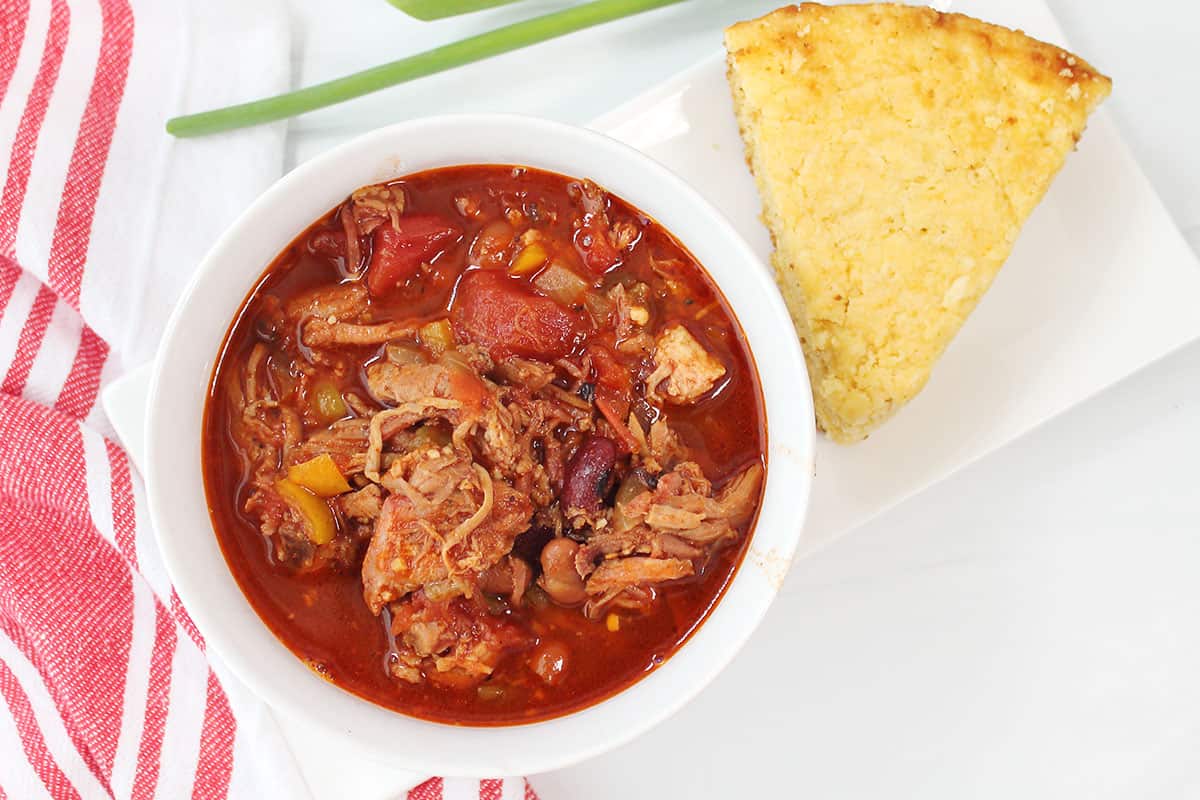 Overhead of BBQ pulled pork chili with cornbread.