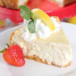 Lemon cheesecake slice with whipped cream, lemon and mint.