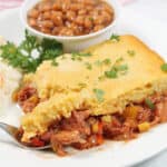 Plated pulled pork casserole with bite on fork.
