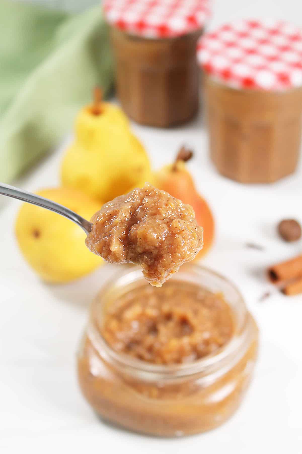 Spoonful of easy pear butter over jar.