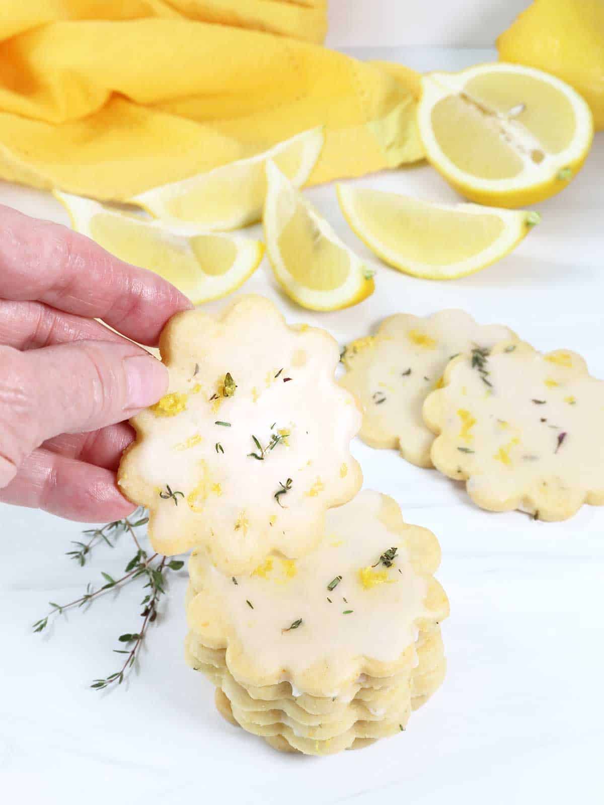 Lifting shortbread cookie from stack.