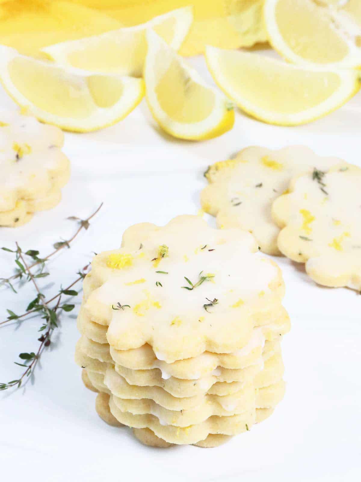 Stacked Lemon Thyme Shortbread Cookies with lemons.